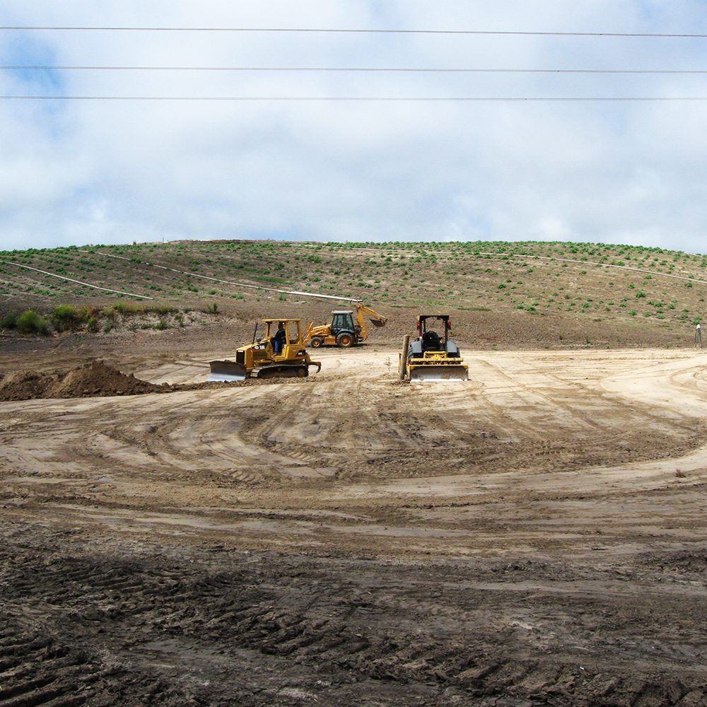Construction of a sediment basin at a mitigation site.